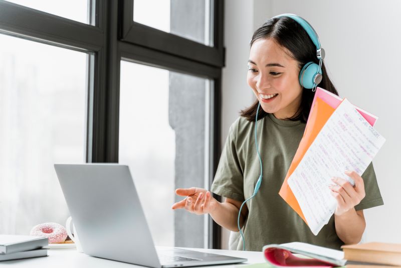 woman-with-headphones-having-video-call-laptop.jpg